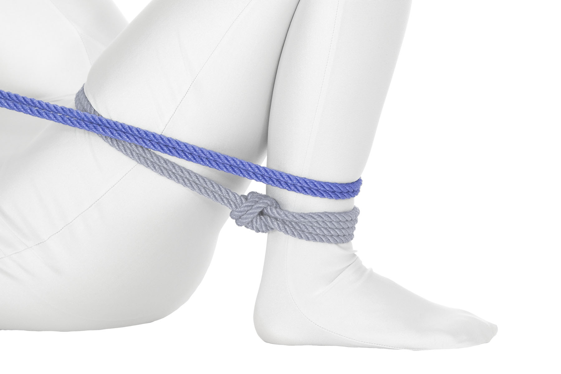 The rope makes a full clockwise pass around the leg, going over the thigh right below the crotch and back down to the ankle. It comes around the shin just above the single column tie.