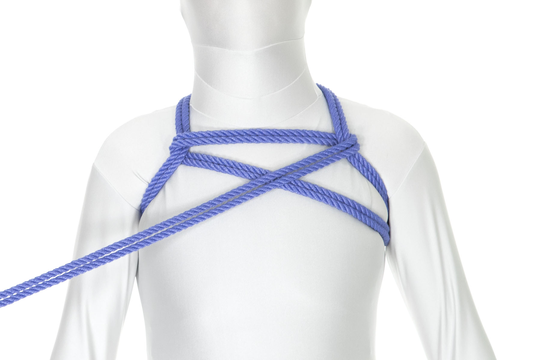 The rope goes under the left shoulder line and doubles back across it, travelling diagonally down and to the left. It crosses over the diagonal rope from step 1 and moves toward the right armpit.