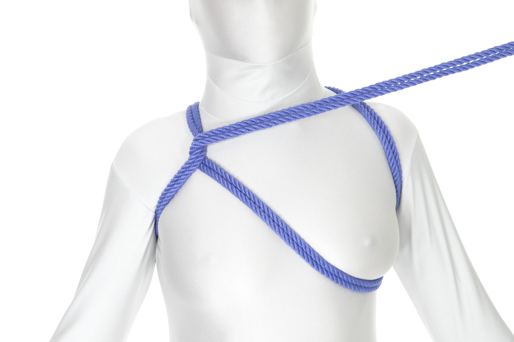 A person with breasts in a white bodysuit. They have a blue shoulder line on each side. A new rope comes under the left shoulder and tucks directly under the left breast before going up to the right shoulder line and doubling back around it.