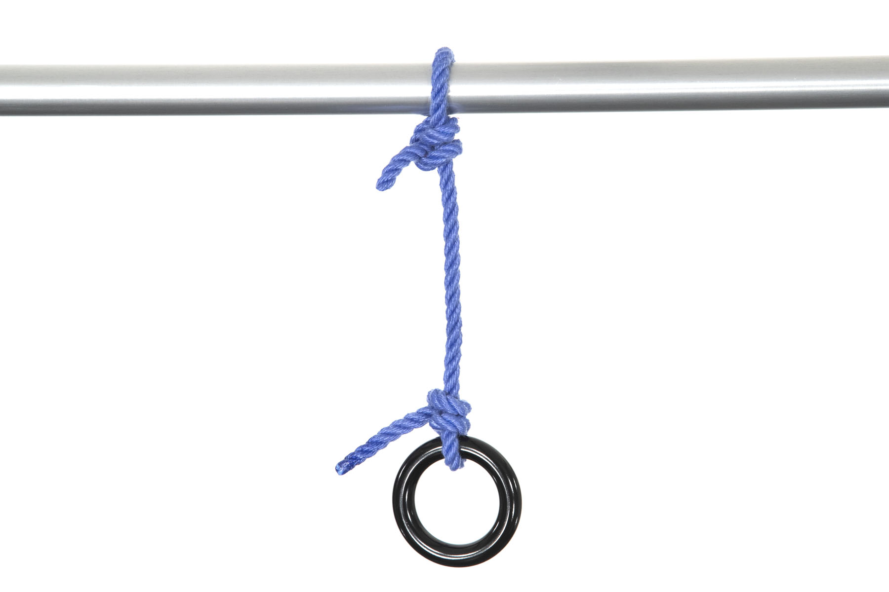 A length of one inch diameter aluminum pipe crosses the frame horizontally. A blue rope is tied to the pipe with two half hitches. Six inches away, the other end of the rope is tied to a rappel ring with two half hitches. The rappel ring is made of shiny black metal and is about two and half inches in diameter. The metal that makes up the ring is about half an inch in diameter.