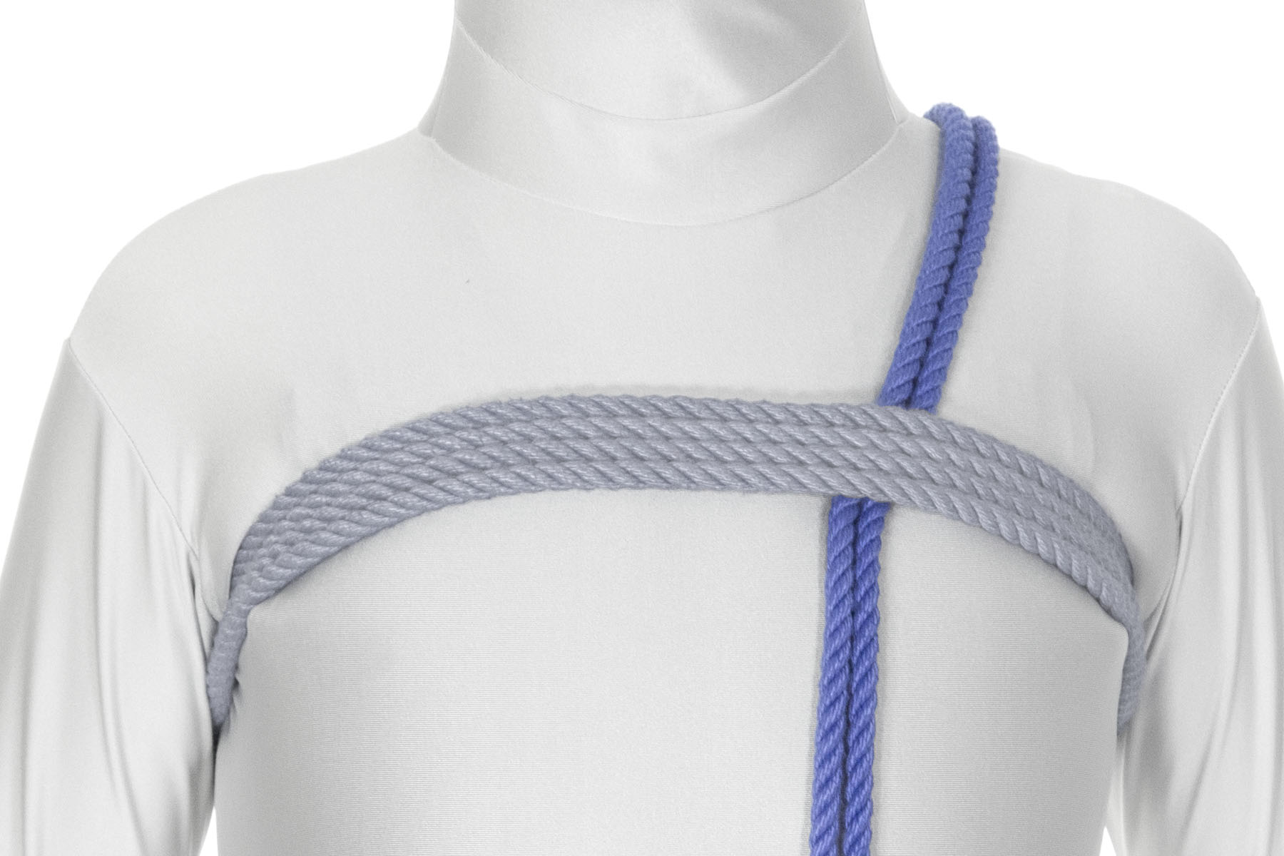 We are looking from the front as the rope comes over the left shoulder and straight down the front of the chest, crossing under the chest wraps.