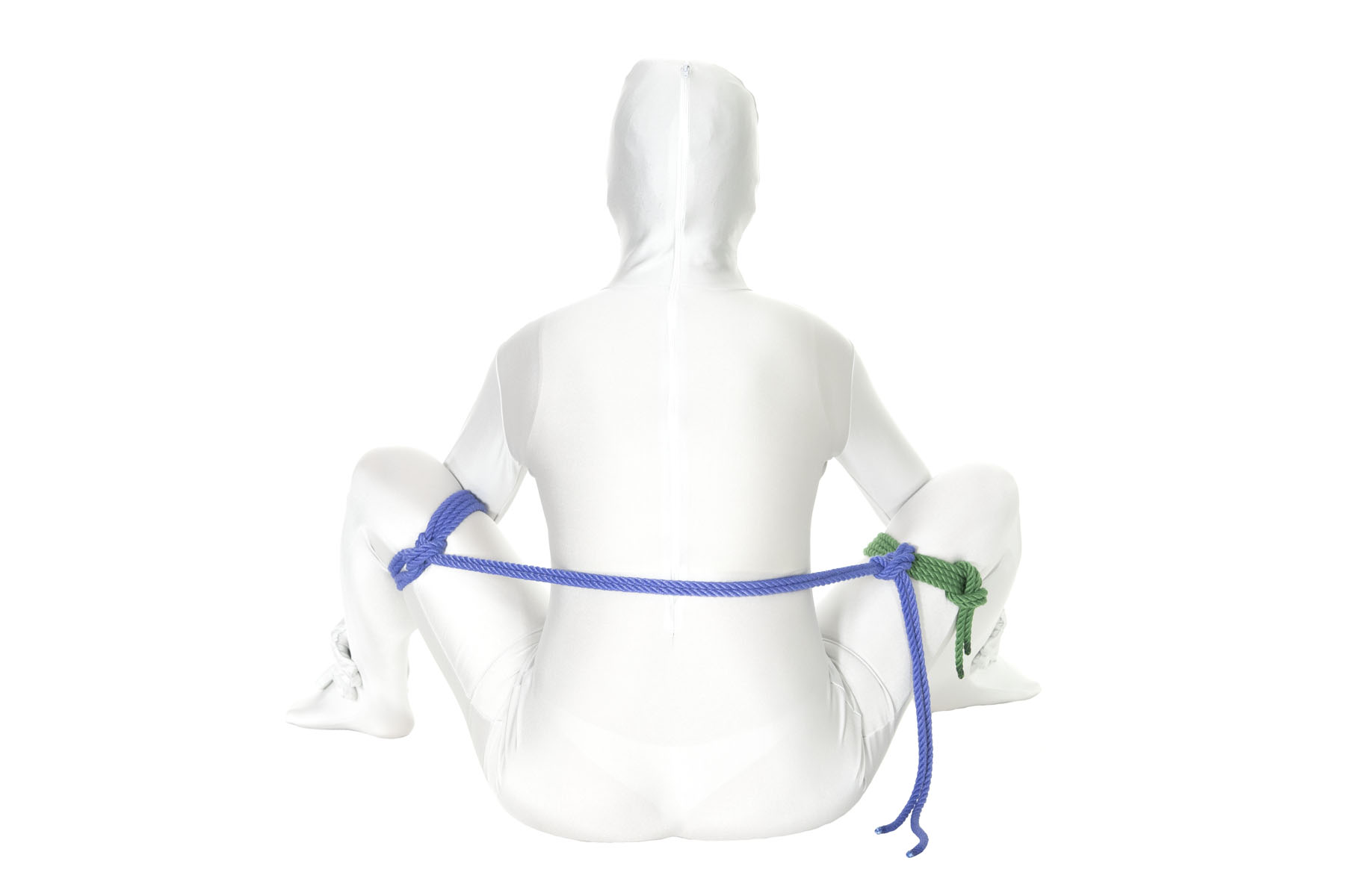 The extra rope from the column tie on the left thigh passes behind the person’s back and is tied to the single column tie on their right thigh with a round turn and two half hitches, pulling the legs apart.