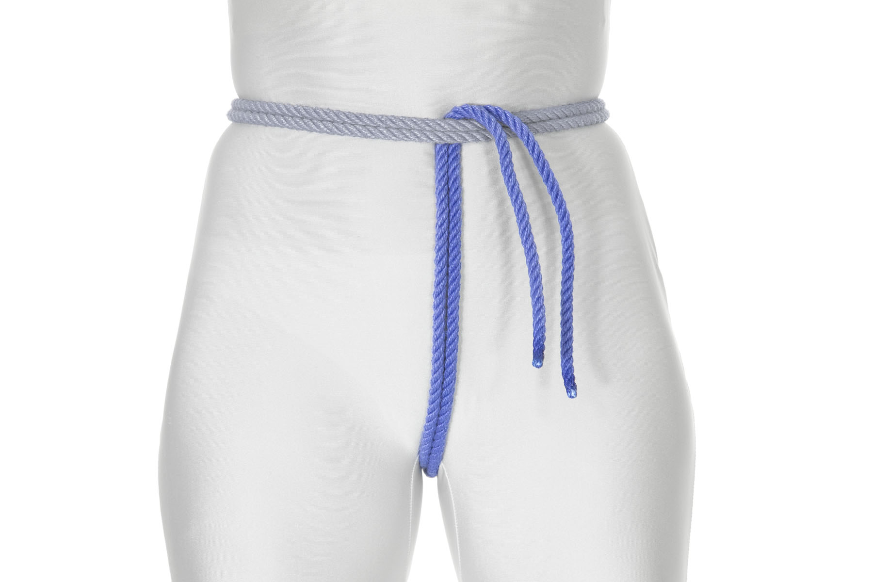 This view is from the front, showing the rope passing between the legs and going up over the crotch to the waist rope. It passes under the waist rope and is pulled snug.