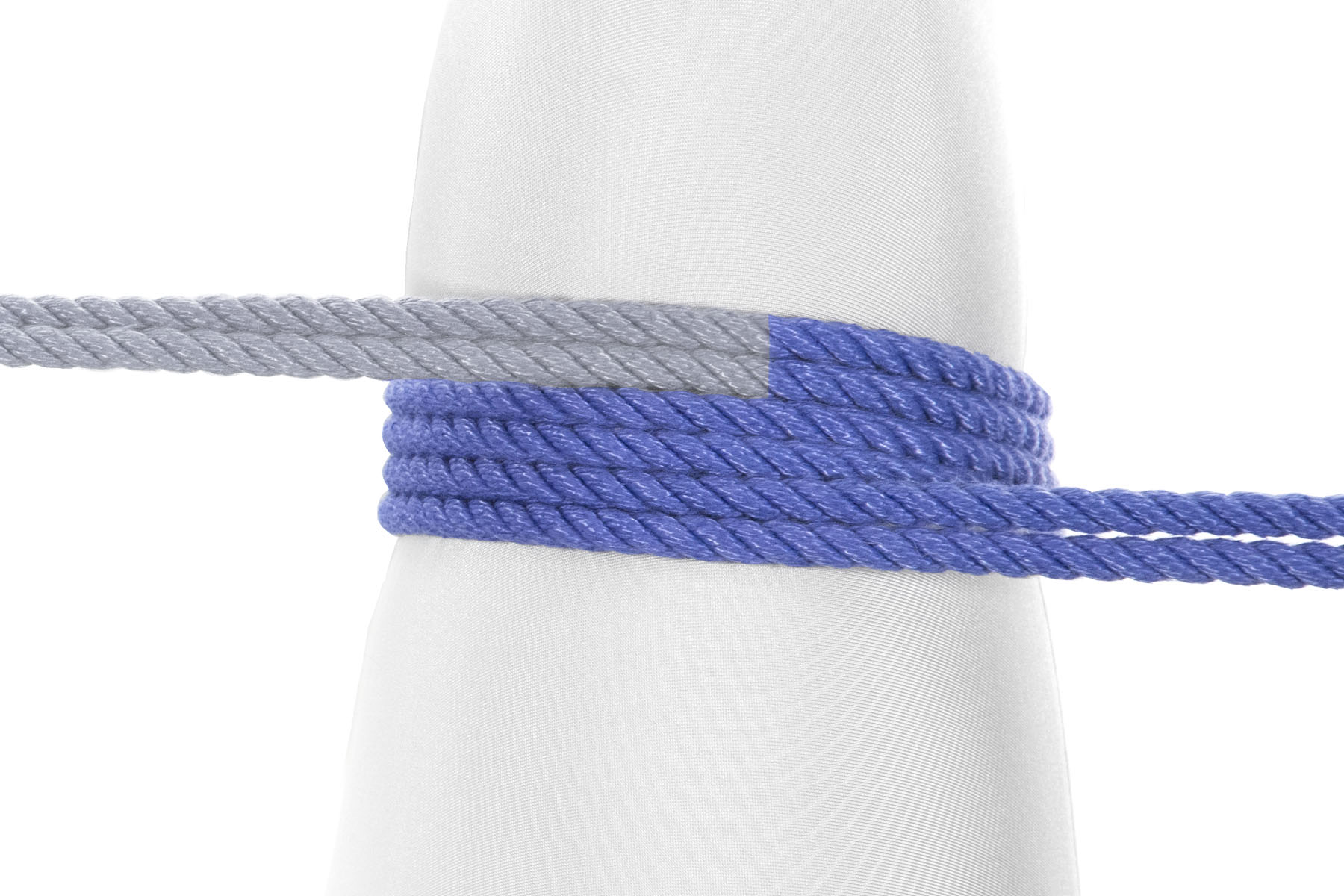 A closeup of the right leg. The rope enters from the left of the image and makes two clockwise wraps around the leg, with each wrap closer to the body than the previous one. The running end then exits to the right of the image.