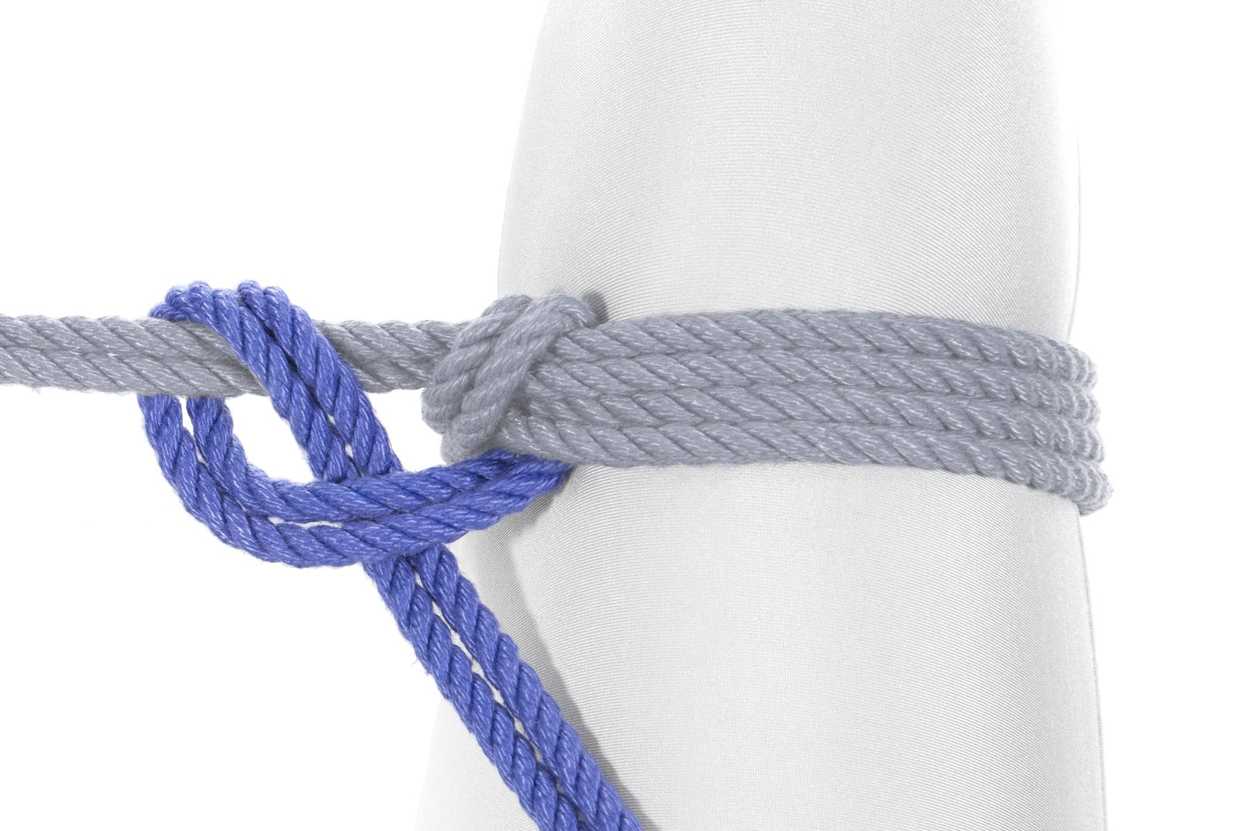 The running end is tied in a half hitch around the original line that entered from the left of the image and went around the leg. It crosses under that line, doubles back over it, then crosses under itself to make a half hitch.