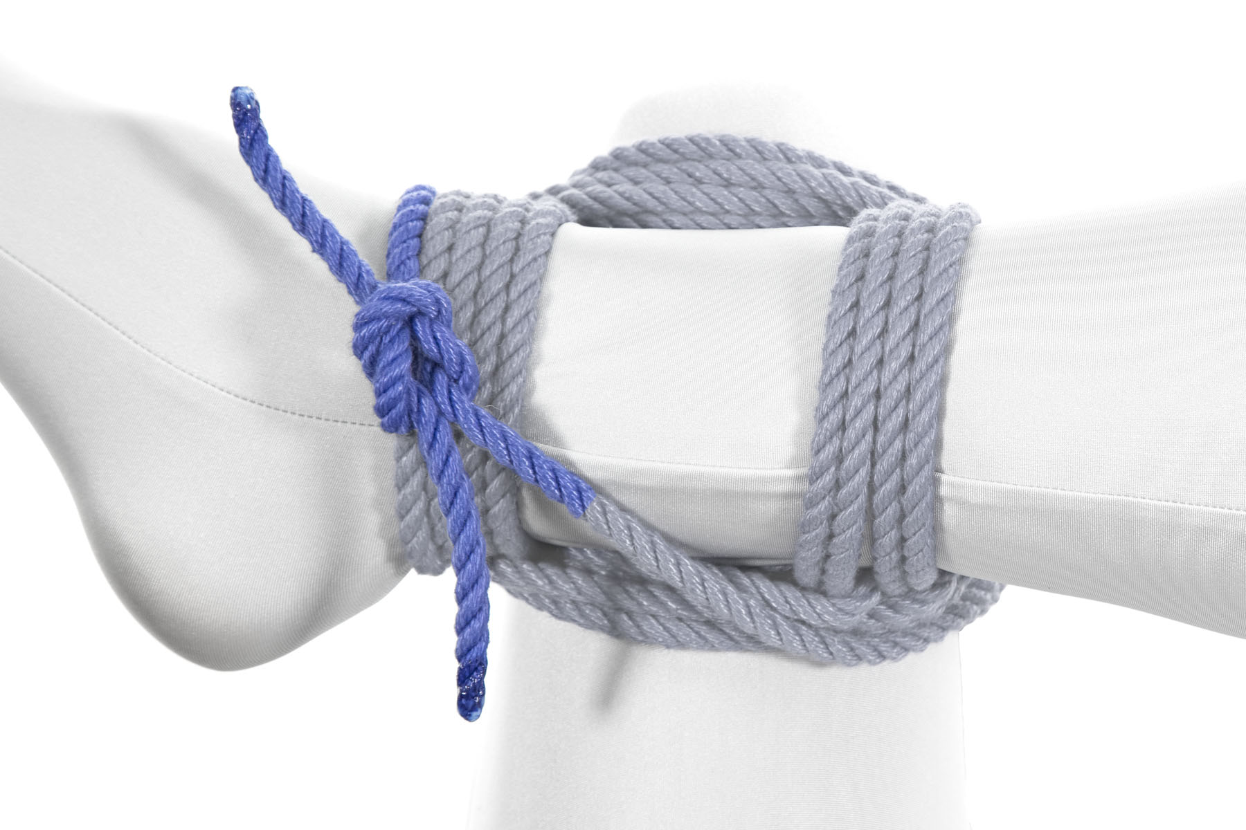 The two ends have been tied together with a square knot that lies on top of the ankle.