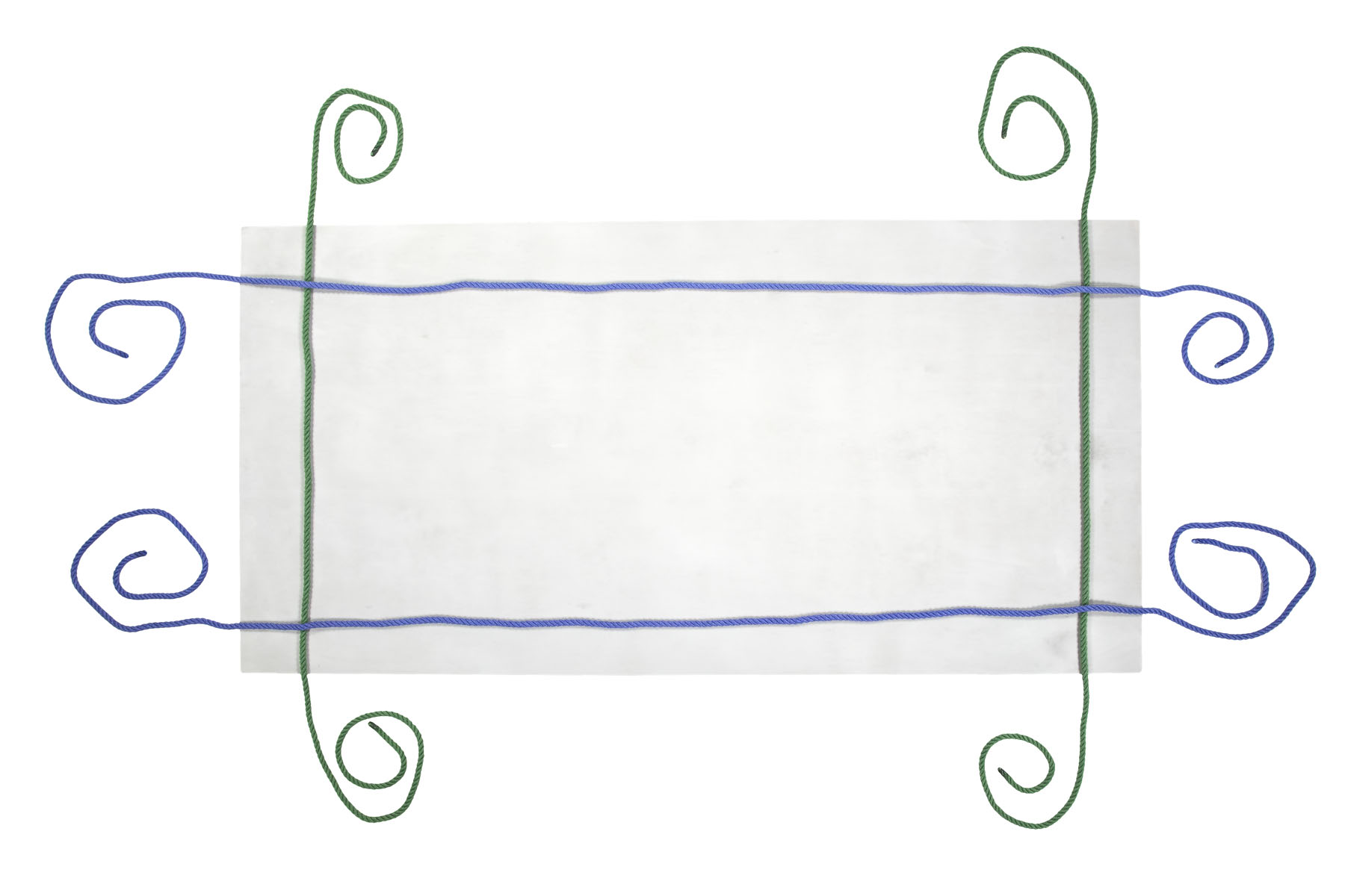 A plain gray board lying on the floor represents a mattress. It is about three feet from left to right and two feet from top to bottom. Two green ropes cross the board vertically, one three inches from the left edge and one three inches from the right edge. Two blue ropes cross the board horizontally, crossing over the green ropes. One is three inches from the top edge and the other is three inches from the bottom edge.