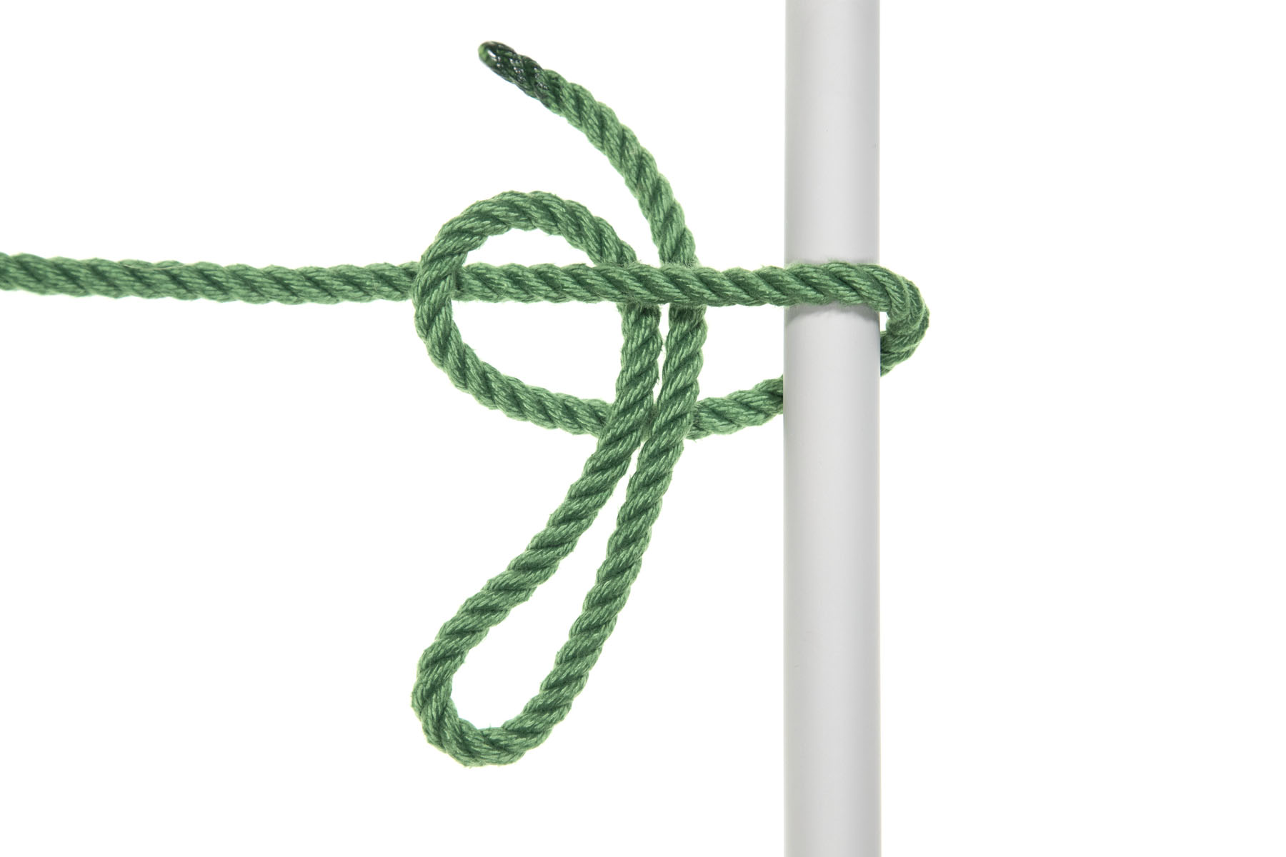 A one inch gray pole crosses the frame vertically. A green rope enters from the left and goes over the pole, doubles back under it, and crosses over the standing part. To this point, it looks exactly like a standard half hitch. But now, instead of passing the end of the rope under the standing part and over itself, the end of the rope is folded into a twelve inch bight bight and the bight crosses under the standing part and over the rope that passed under the pole. We are effectively tying a half hitch in the bight.