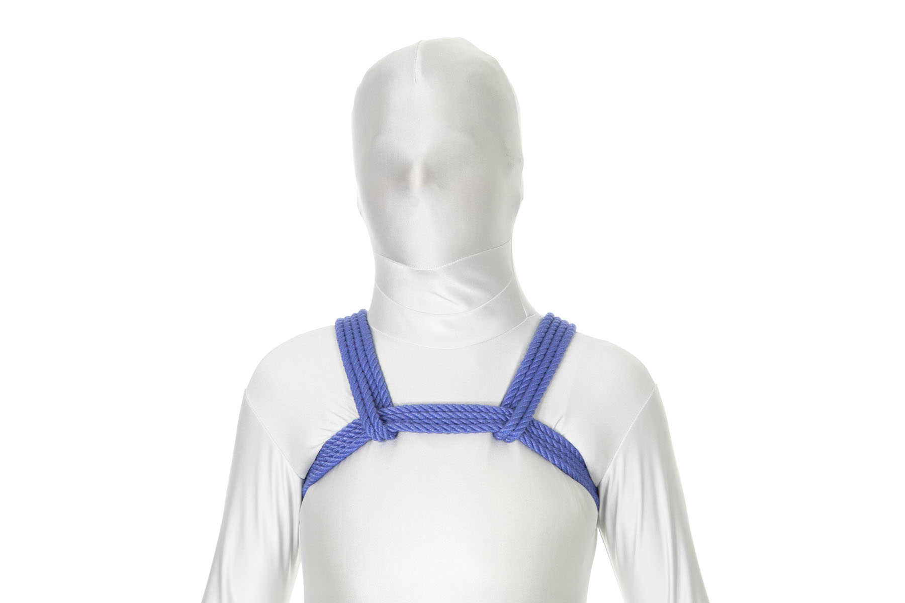 A person in a white bodysuit wearing a chest harness made of blue rope. A band of four strands of blue rope crosses high on their chest and goes under their armpits. A doubled rope comes over each shoulder, goes under the chest wrap, and then doubles back and goes over the shoulder.