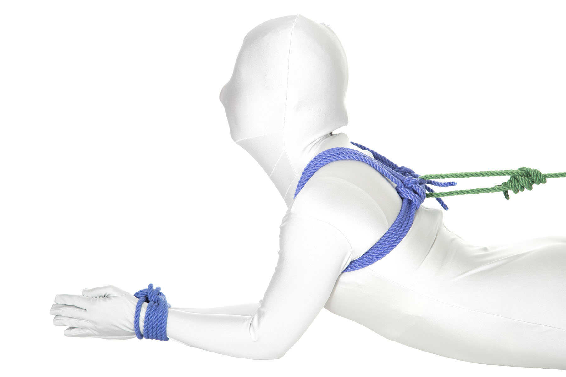 This image shows an adaptation for the hogtie for people who aren’t comfortable with their hands behind their back. The person in the image has their arms in front of them, with the elbows bent and the forearms resting flat on the floor. The wrists are tied together with a column tie.