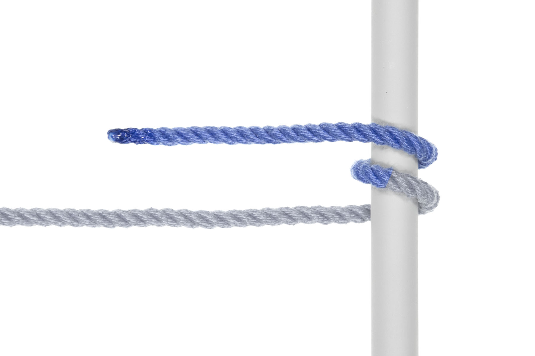 The rope wraps once around the pole, moving upward. It now makes a spiral shape going up the pole, with the end again pointing toward the left.