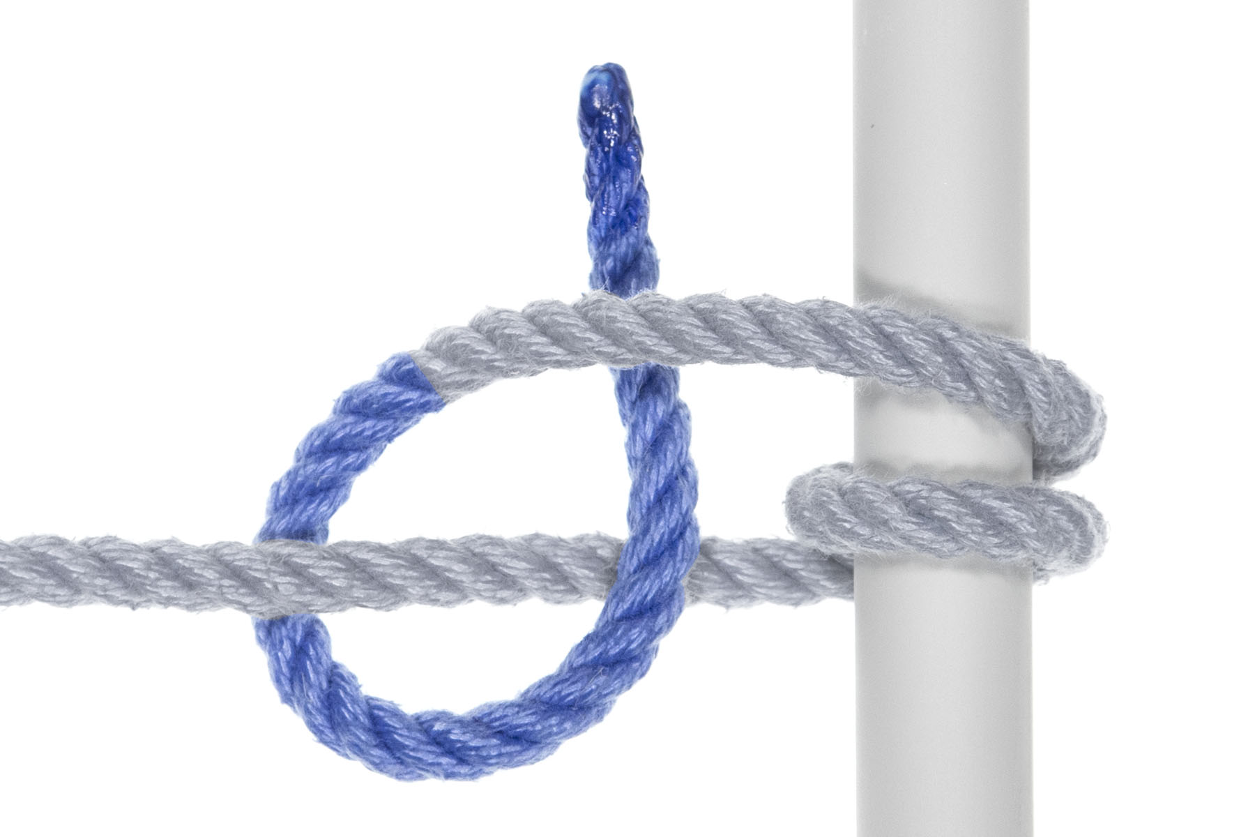 The working end crosses under the standing end, then turns toward the pole and crosses over the standing end and then under itself, making a half hitch.