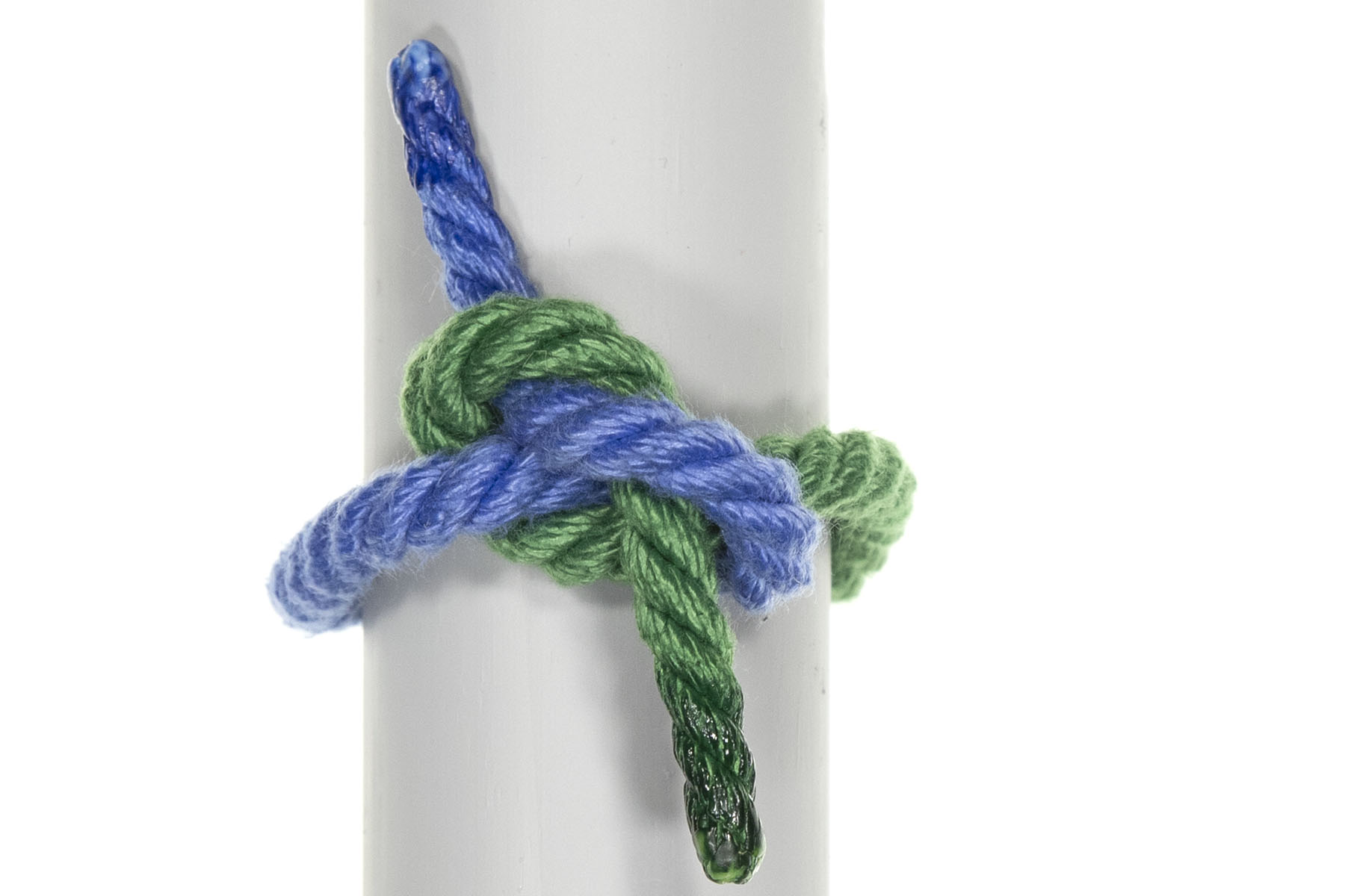 This is a granny knot, which looks much more jumbled than the square knot. It does not lie flat on the pole, and the working ends exit the knot at 90 degrees from the standing parts, rather than lying flat next to them.