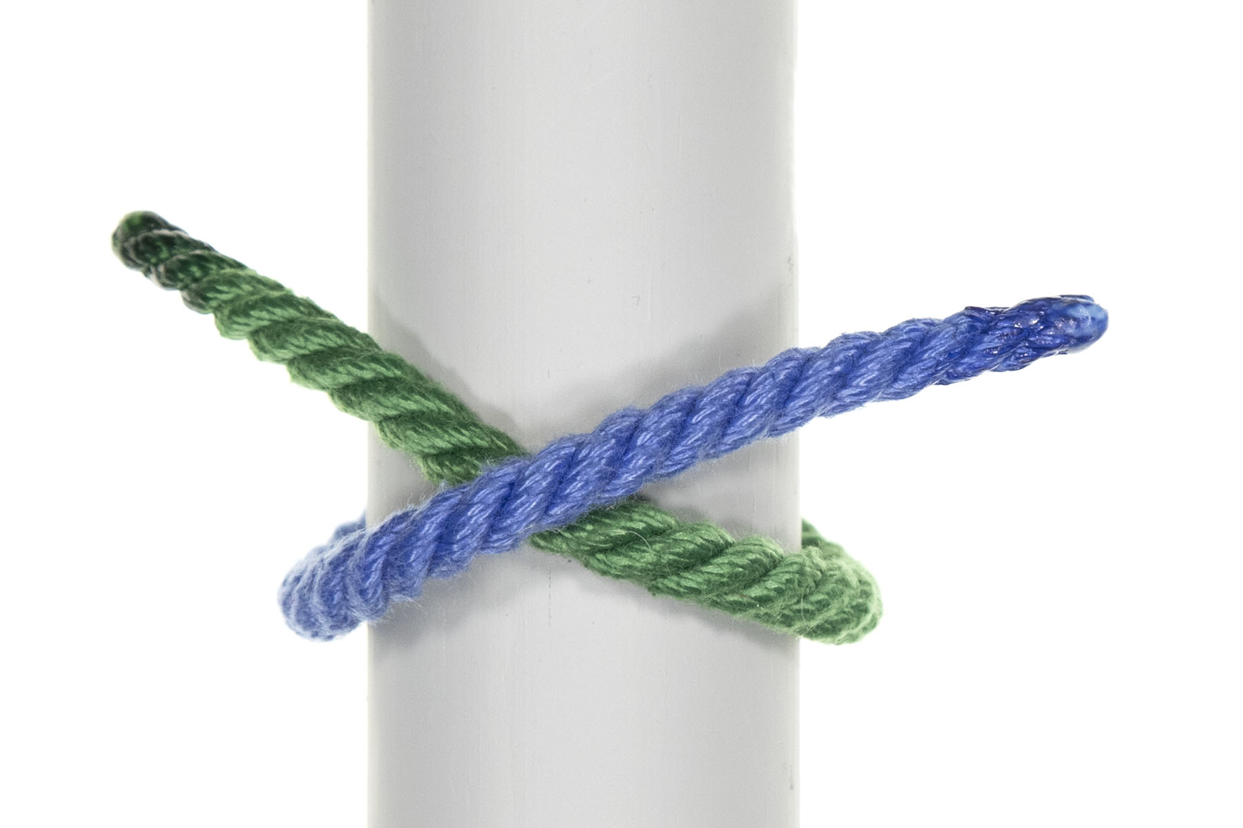 A three inch diameter gray pole divides the frame vertically. A green rope emerges from behind the pole on the right side and goes upward around the pole at a 30 degree angle. About two inches of rope extend beyond the left edge of the pole. A blue rope mirrors the green one, entering from the left and crossing over the green rope.