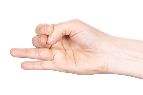 A hand with two fingers extended straight ahead. The thumb is bent and the index and middle fingers are resting on the thumbnail and pushing the thumb into a bent position. The thumb is trying to straighten by pushing against the fingers.