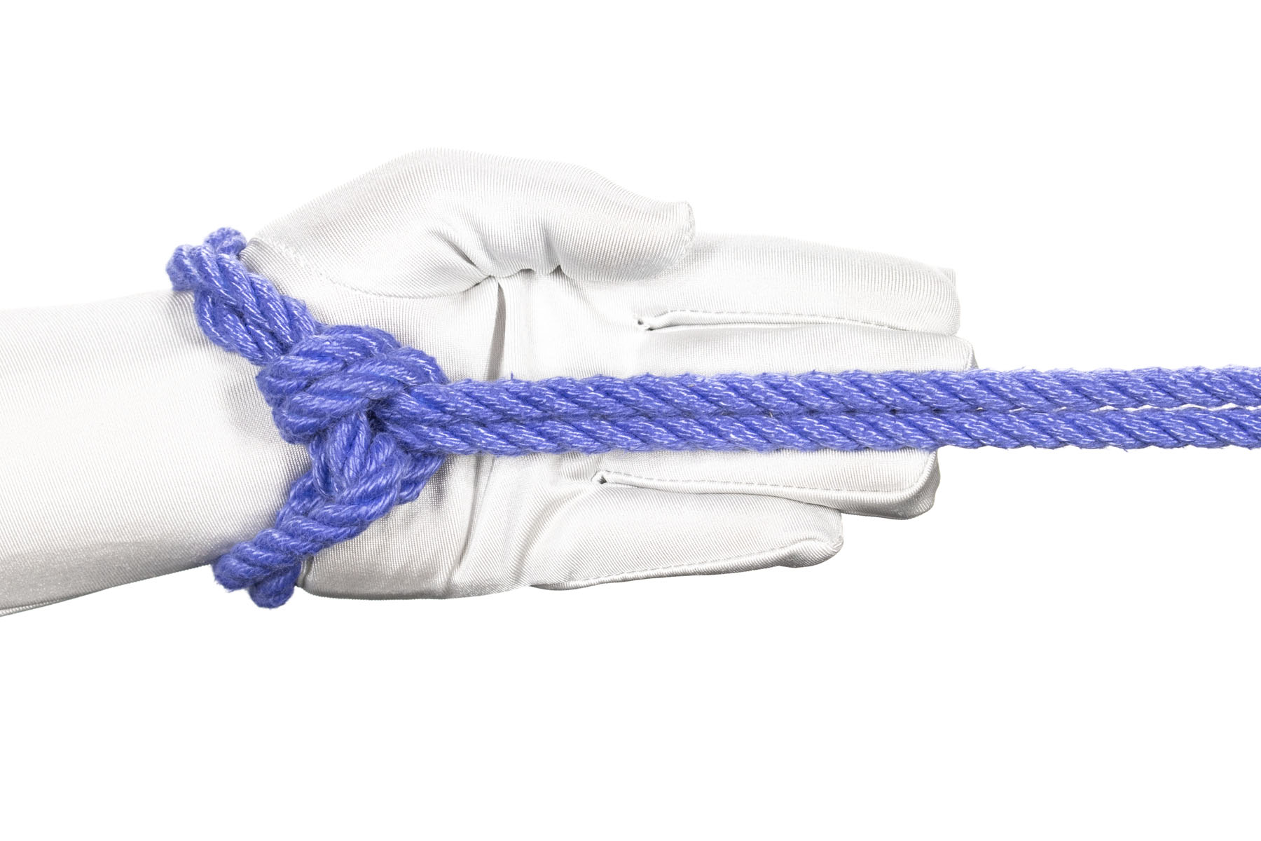 A hand pointing to the right with a single column tie with one wrap tied around it. The rope exits the half hitch facing to the left, so when the rope is pulled to the right the half hitch flips over, creating twists in the wraps that go around the wrist.