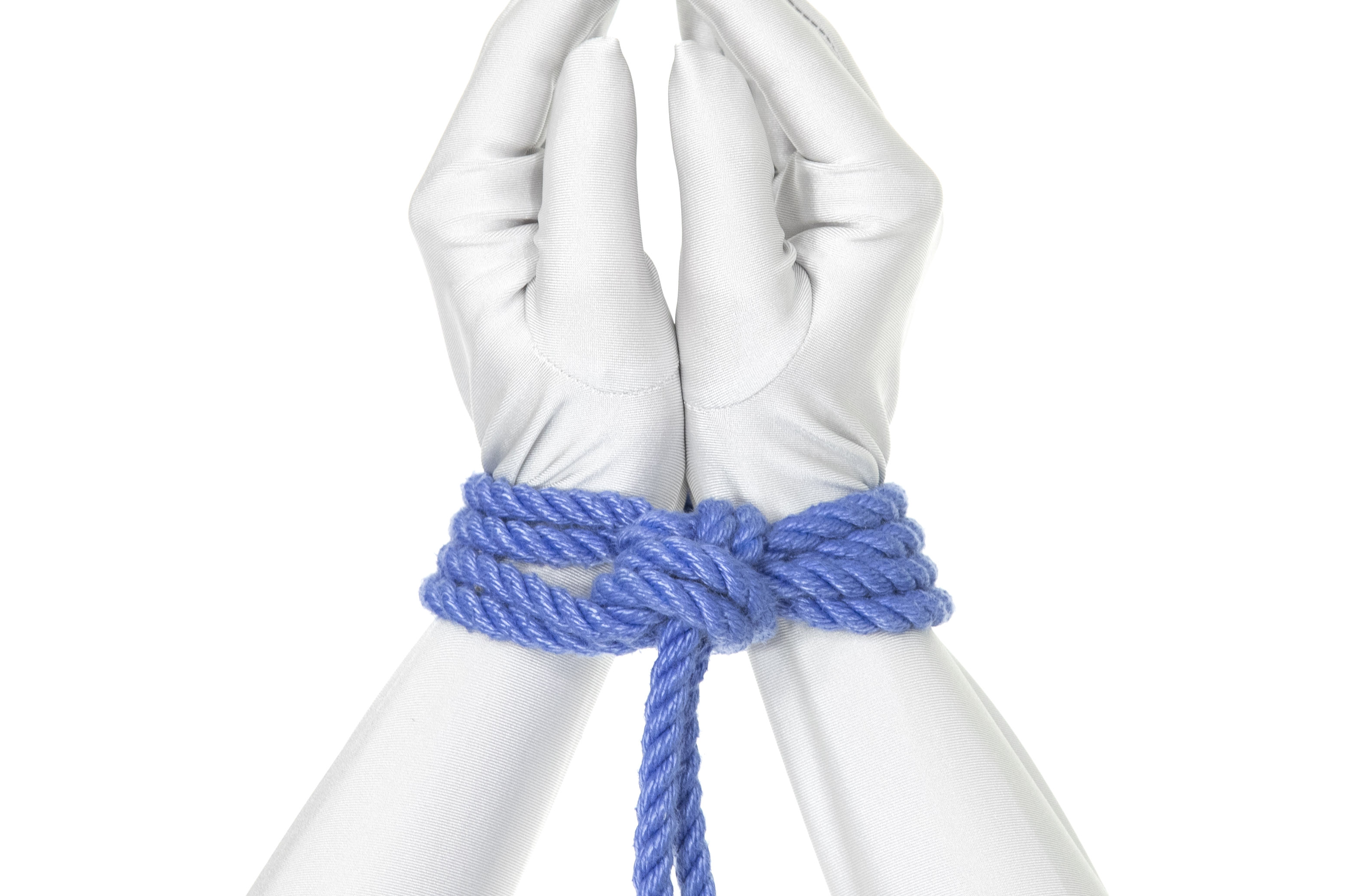 Two hands in a white bodysuit tied together at the wrists with blue rope.