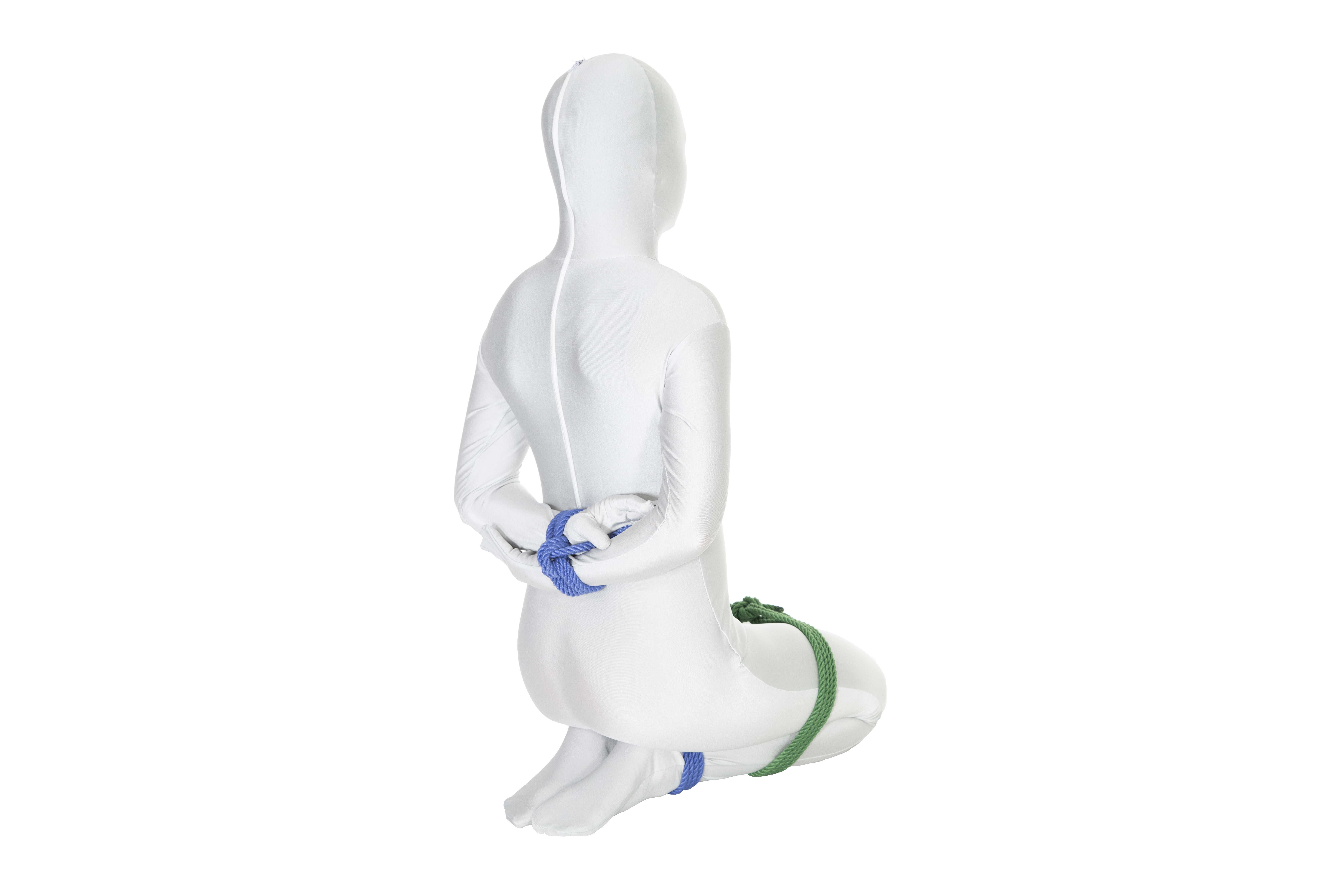 A person in a white bodysuit kneeling with their hands bound behind their back.