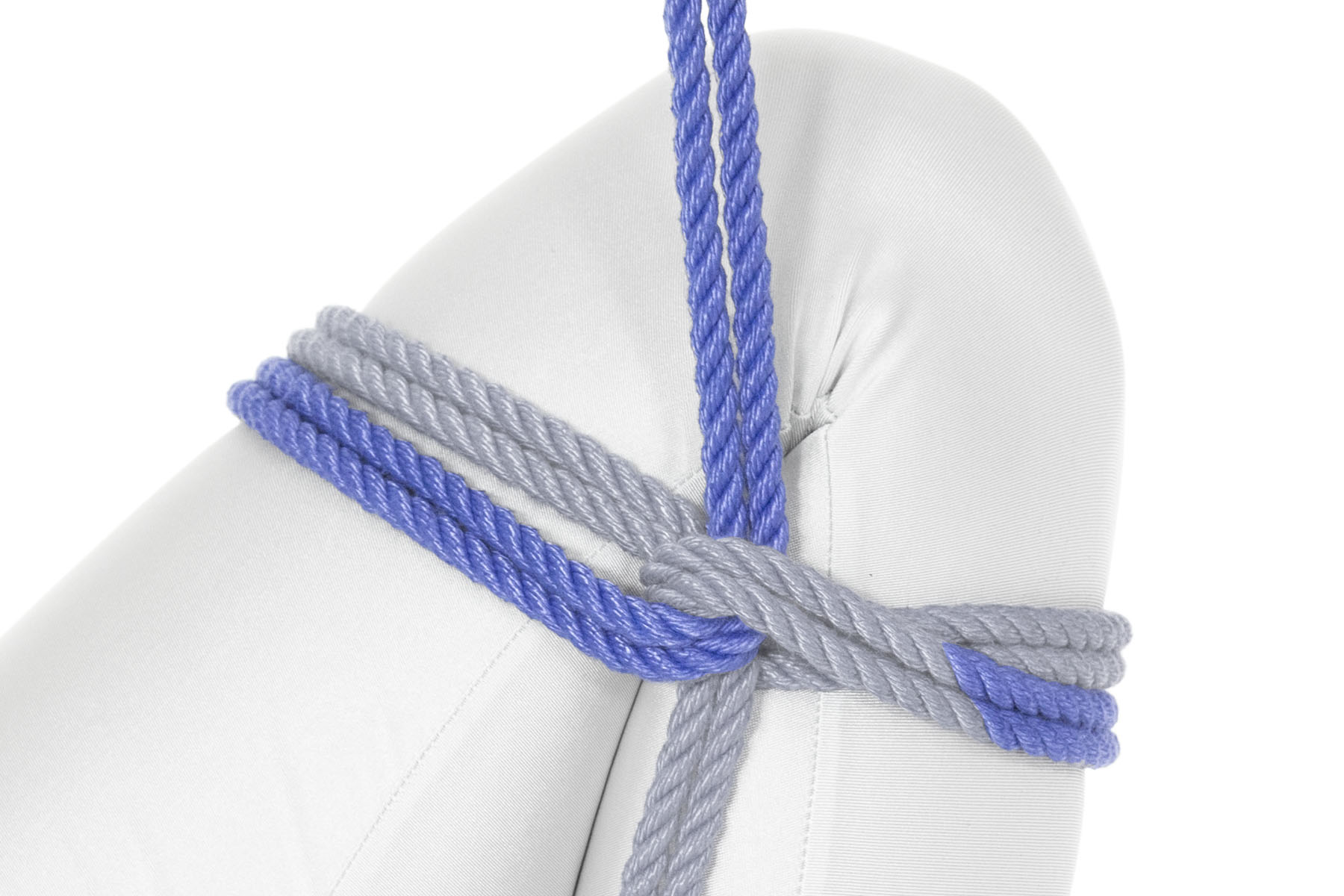 The rope makes a complete counter-clockwise wrap around the leg, just below the first wrap. It then goes through the U of the first reverse tension and reverses direction, making a second reverse tension.