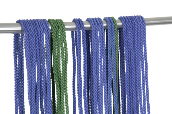 An aluminum rod crossed the frame horizontally. Various lengths of blue and green rope have been hung over the rod to dry.