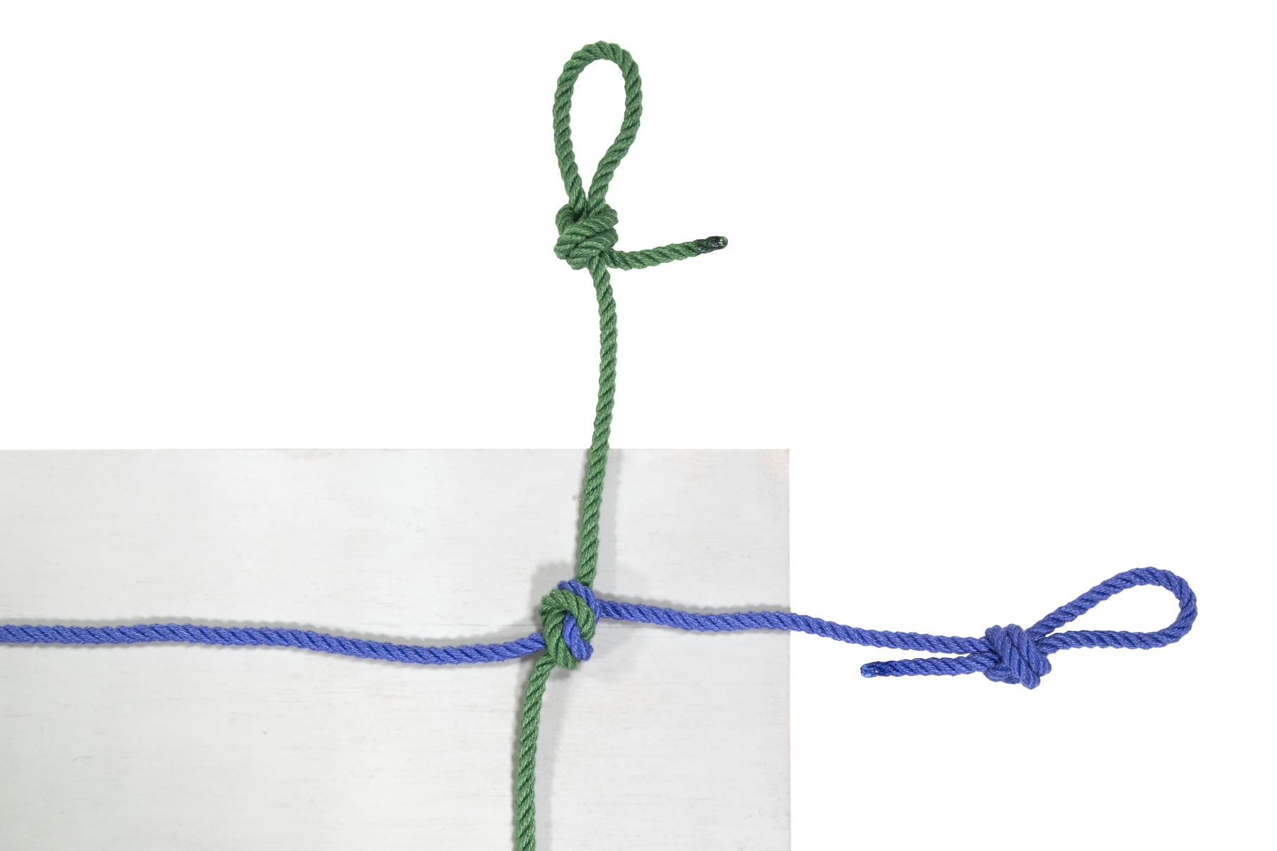 The ropes lie in the same position as before, but they are now tied together with an overhand knot at the point where the blue rope crossed the green rope.