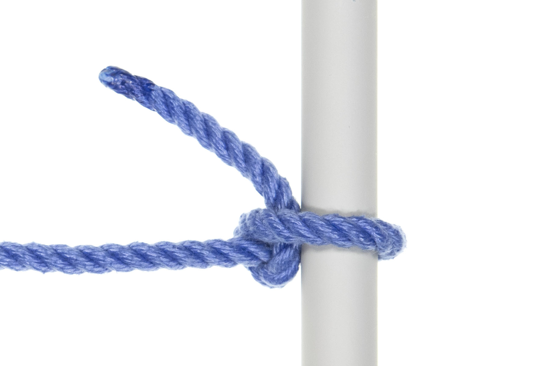 A half hitch tied around a one inch gray pole. The rope goes around the pole, around the standing part, and under itself, making a compact knot right against the pole.