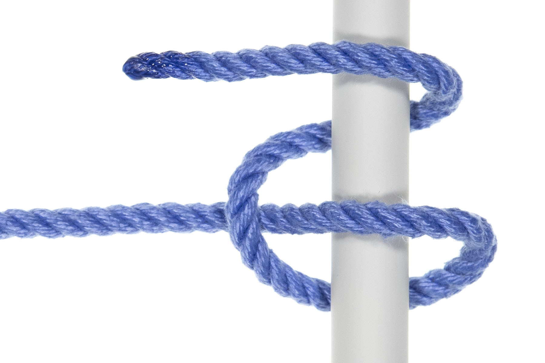 A one inch gray pole crosses the frame vertically. A blue rope enters from the left and crosses over the pole, then crosses under it, slightly lower in the frame. It crosses over the standing part, moving up the frame. Next, it crosses under the pole, then back over it, moving up the frame the whole time.