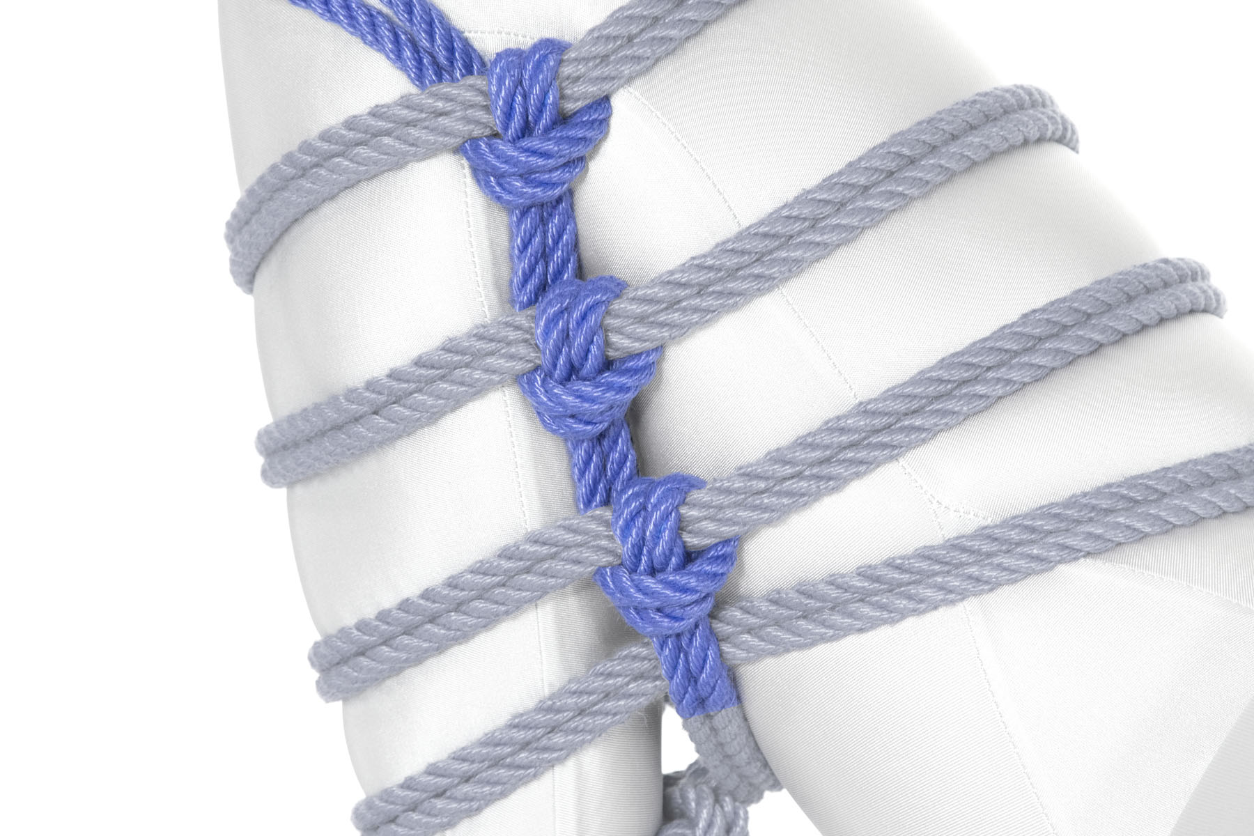 The rope travels up the crease between the thigh and shin, making three Munter frictions as it crosses itself.